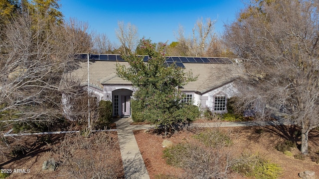 view of front of property with solar panels