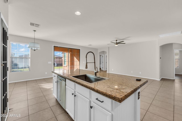 kitchen featuring ceiling fan, dishwasher, sink, a center island with sink, and white cabinets