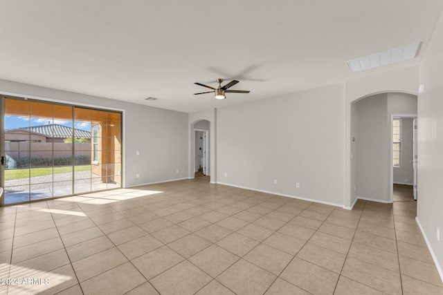 empty room featuring ceiling fan and light tile patterned floors