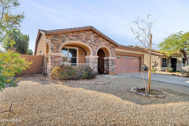 view of front of house featuring a porch and a garage