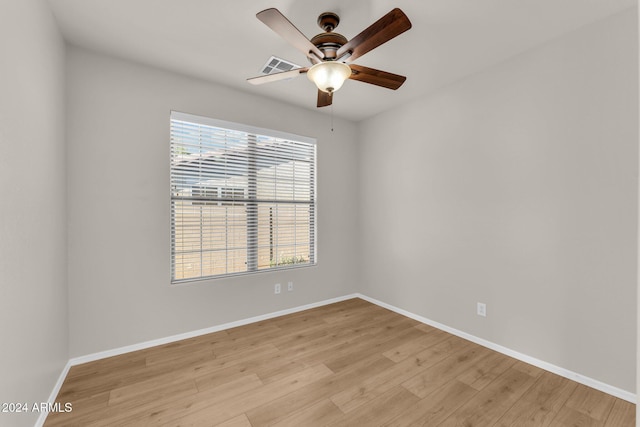 empty room with light hardwood / wood-style flooring and ceiling fan