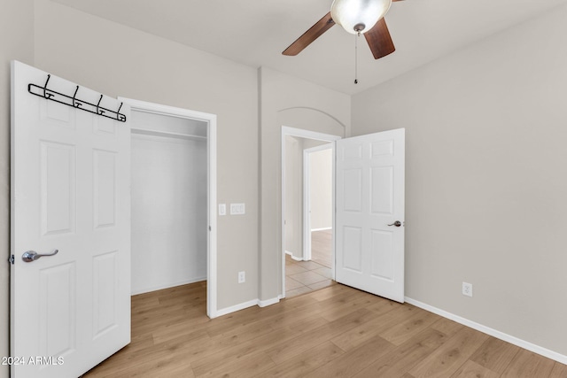 unfurnished bedroom featuring a closet, light hardwood / wood-style floors, and ceiling fan