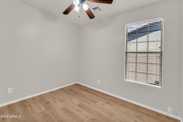 spare room with ceiling fan, light hardwood / wood-style floors, and a wealth of natural light