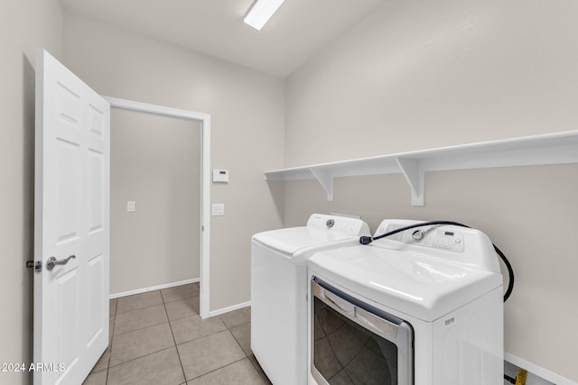 washroom with independent washer and dryer and light tile patterned floors