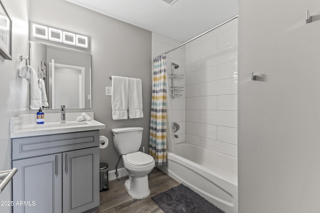 full bathroom with vanity, hardwood / wood-style floors, toilet, and shower / bath combo