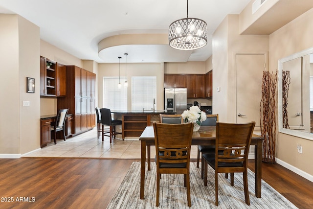 dining area with a chandelier and light wood-type flooring