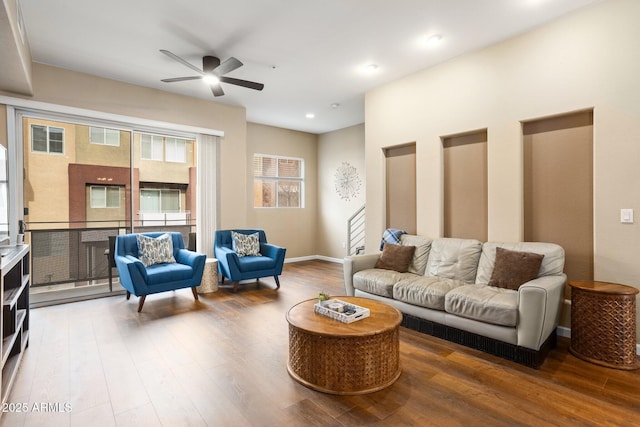 living room with hardwood / wood-style floors and ceiling fan