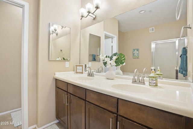 bathroom with vanity, tile patterned flooring, and a shower with door