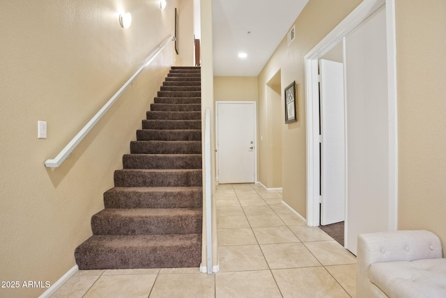 stairway with tile patterned flooring