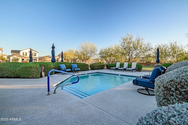 view of swimming pool featuring a fenced in pool, a patio area, and fence