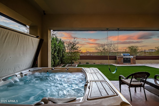 exterior space featuring fence, a grill, a lawn, and a hot tub