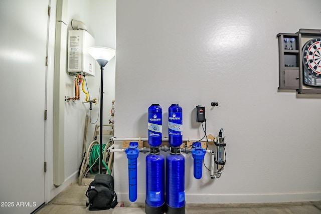 utility room featuring water heater