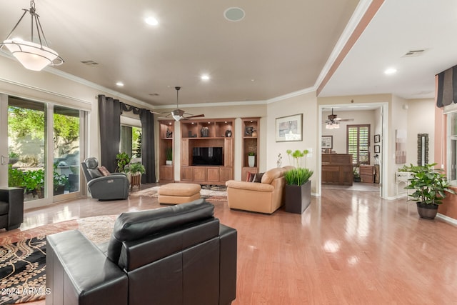 living room featuring ceiling fan, light hardwood / wood-style floors, and crown molding