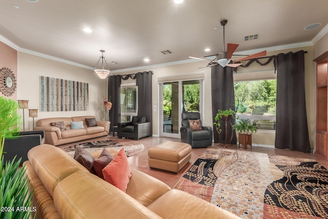 living room featuring ceiling fan and crown molding