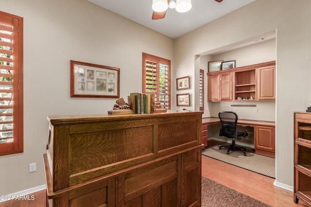 12832 W Pinnacle Vista Dr, Peoria, AZ 85383 - home office featuring a ceiling fan, light wood-style floors, built in study area, and baseboards