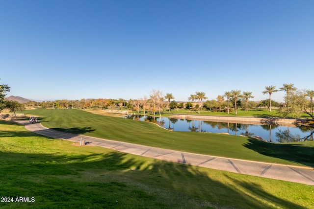 view of community featuring a lawn and a water view