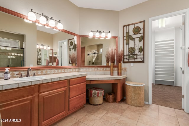 bathroom featuring vanity, tile patterned floors, and a shower with shower door