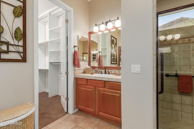 12832 W Pinnacle Vista Dr, Peoria, AZ 85383 - bathroom featuring a stall shower, vanity, a walk in closet, and tile patterned floors