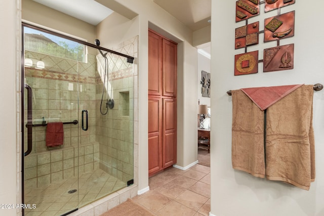 bathroom with tile patterned flooring and walk in shower