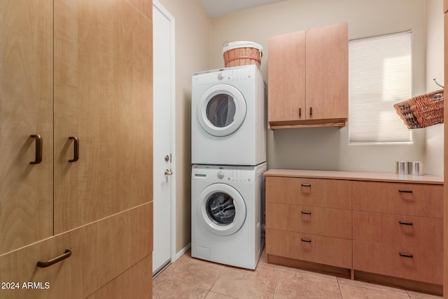 12832 W Pinnacle Vista Dr, Peoria, AZ 85383 - laundry area with estacked washer and dryer, cabinet space, and light tile patterned floors