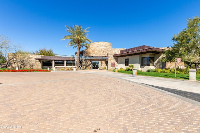 12832 W Pinnacle Vista Dr, Peoria, AZ 85383 - view of front of house with stone siding, stucco siding, and decorative driveway
