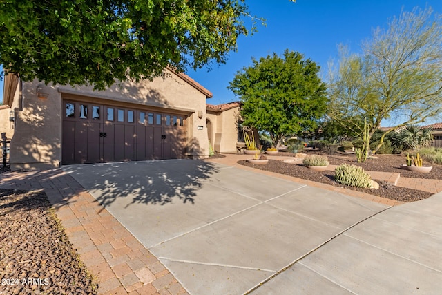 mediterranean / spanish-style home with a garage