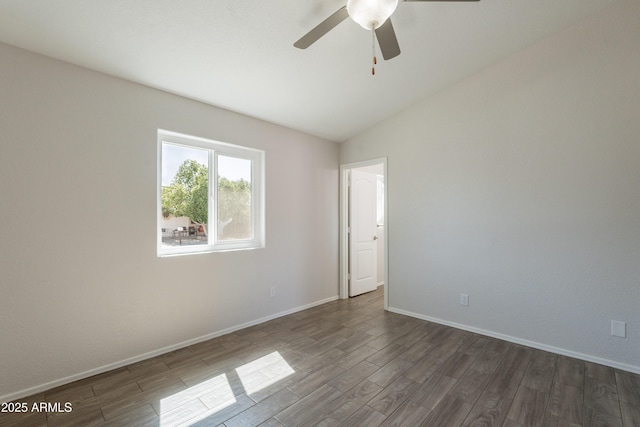 empty room featuring ceiling fan, lofted ceiling, baseboards, and wood finished floors