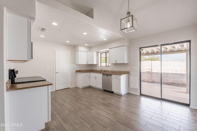 kitchen with a sink, stainless steel dishwasher, light wood finished floors, and visible vents