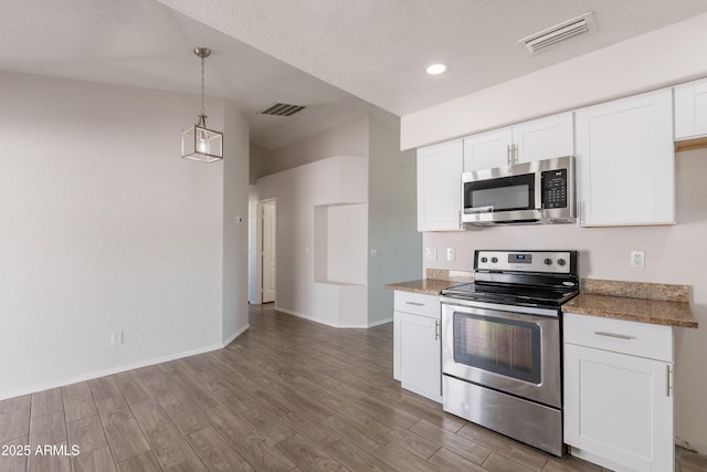 kitchen featuring stainless steel appliances, visible vents, and wood finished floors
