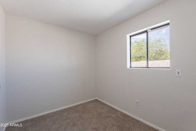 unfurnished room featuring baseboards and carpet