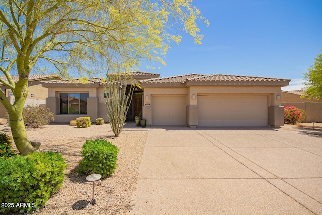 9747 S 182nd Dr, Goodyear, AZ 85338 - view of front of home with an attached garage, driveway, stucco siding, and a tile roof