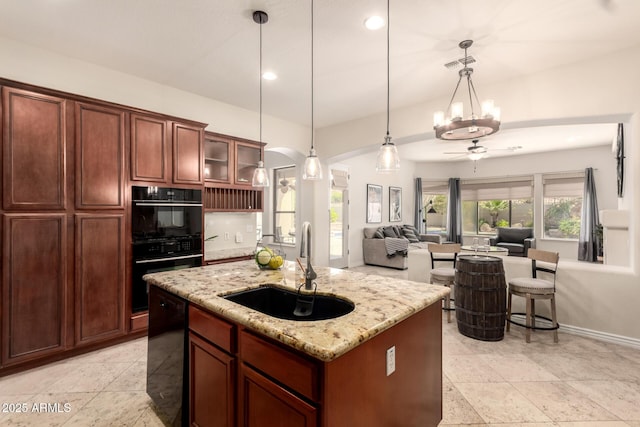 9747 S 182nd Dr, Goodyear, AZ 85338 - kitchen featuring a sink, light stone counters, glass insert cabinets, visible vents, and black appliances