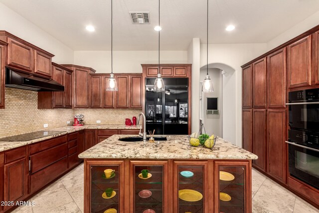 9747 S 182nd Dr, Goodyear, AZ 85338 - kitchen with visible vents, a sink, under cabinet range hood, black appliances, and backsplash