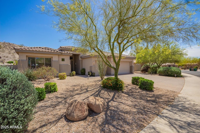 9747 S 182nd Dr, Goodyear, AZ 85338 - view of front of house with concrete driveway, stucco siding, an attached garage, and a tile roof