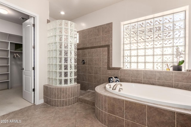 9747 S 182nd Dr, Goodyear, AZ 85338 - full bath featuring a spacious closet, tile patterned floors, walk in shower, a bath, and visible vents