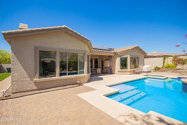 9747 S 182nd Dr, Goodyear, AZ 85338 - rear view of property with a patio, stucco siding, a tiled roof, fence, and roof mounted solar panels