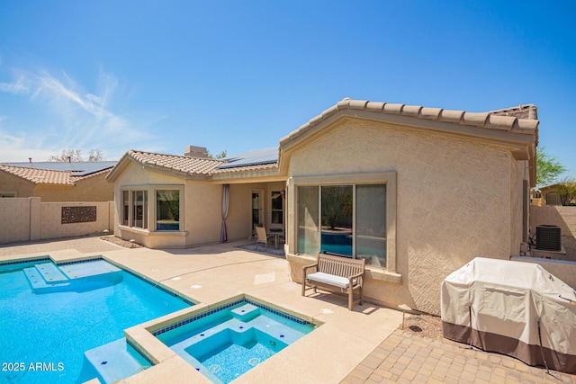 9747 S 182nd Dr, Goodyear, AZ 85338 - rear view of property featuring roof mounted solar panels, a patio area, stucco siding, and a tile roof