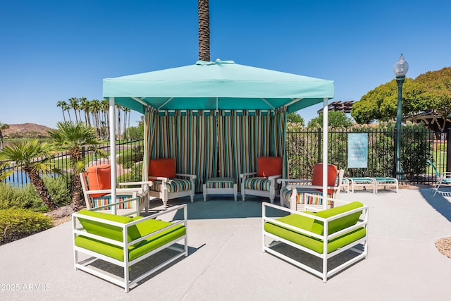 9747 S 182nd Dr, Goodyear, AZ 85338 - view of patio featuring a water view, a gazebo, an outdoor living space, and fence