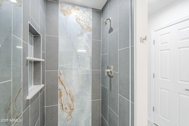 bathroom with a tile shower
