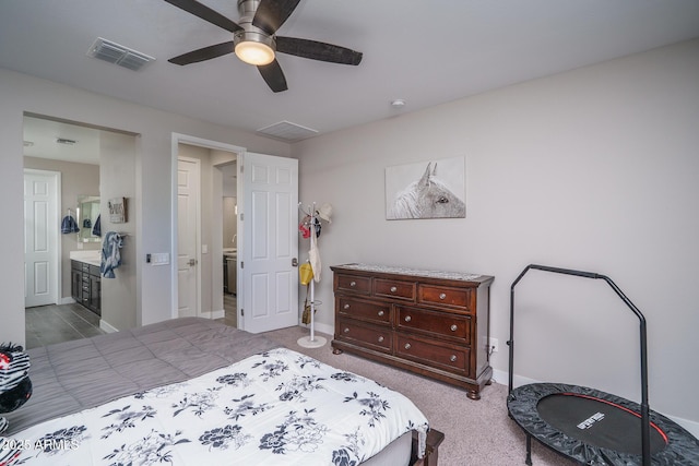 carpeted bedroom with baseboards, ceiling fan, ensuite bath, and visible vents