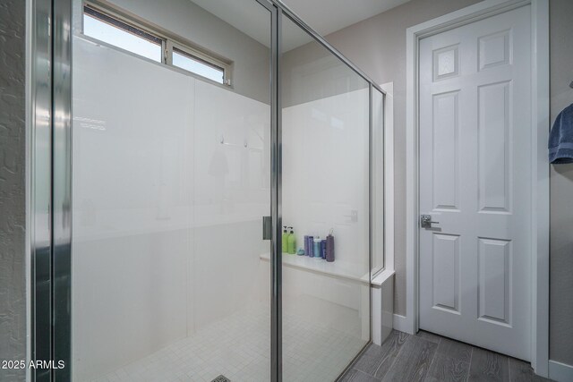 bathroom featuring a shower stall and wood finished floors