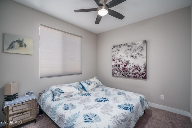 carpeted bedroom with ceiling fan and baseboards