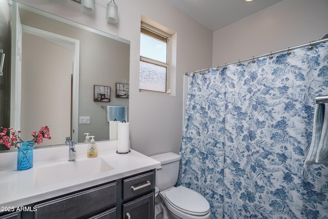 bathroom featuring toilet, a shower with curtain, and vanity