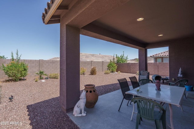 view of patio featuring outdoor dining area and a fenced backyard
