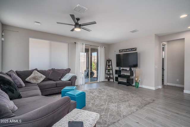 living room with baseboards, a ceiling fan, recessed lighting, and visible vents