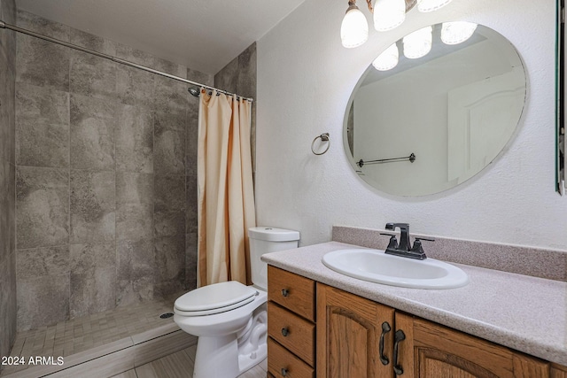 bathroom featuring walk in shower, vanity, toilet, and tile patterned floors