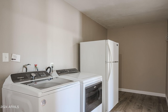 washroom featuring washer and dryer and dark wood-type flooring