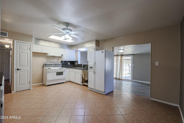 kitchen featuring ceiling fan, sink, white appliances, a textured ceiling, and white cabinetry