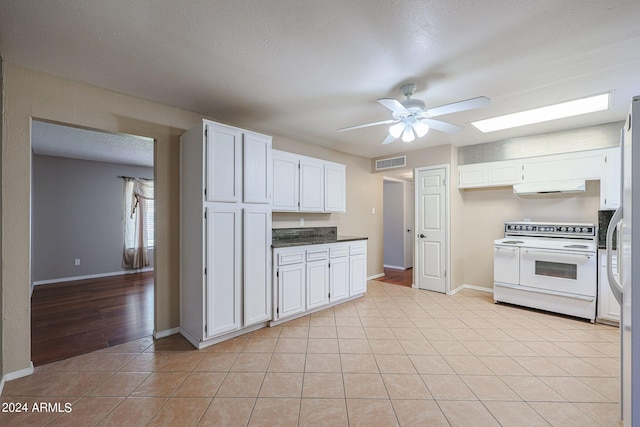 kitchen with ceiling fan, range hood, white appliances, and white cabinetry