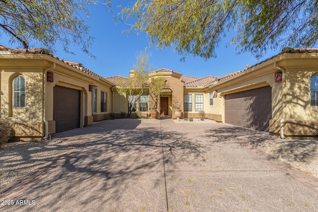 mediterranean / spanish-style home with a garage